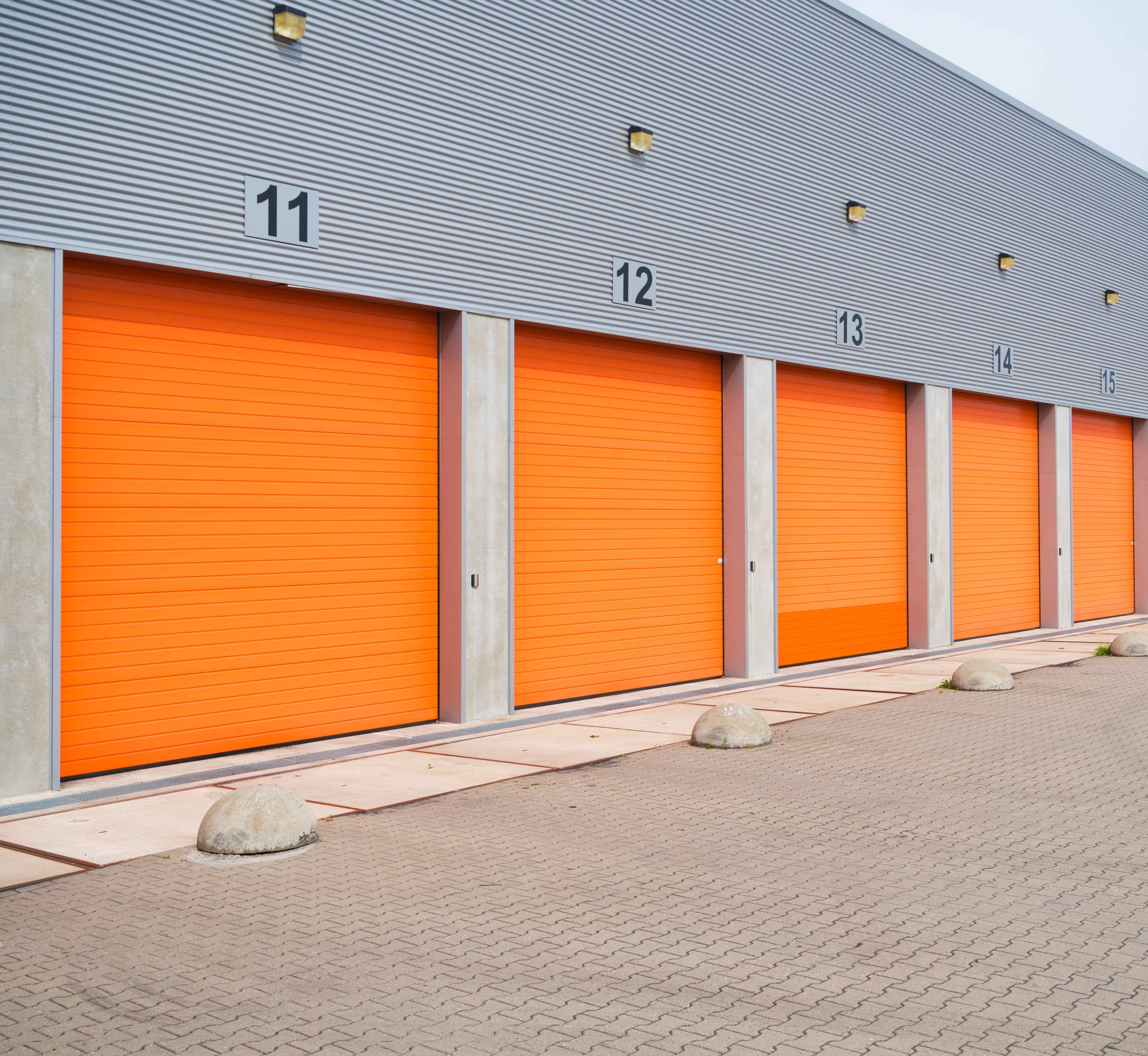 small business units with orange roller doors